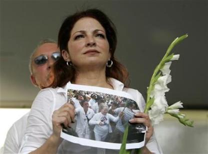 Recording artist Estefan and her husband look towards the crowd as they lead a protest in support of Cuba's Las Damas de Blanco on Calle Ocho in the Little Havana neighborhood of Miami,